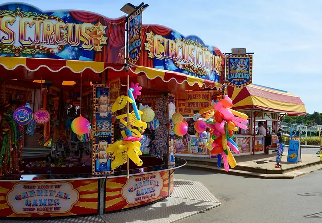 Colorful outdoor carnival game stalls with vibrant toys and decorations, capturing a lively fair atmosphere.